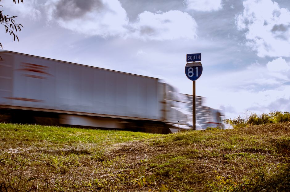 A tractor-trailer passing an Interstate 81 South sign