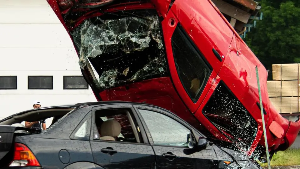 A red car and a black sedan after a two-car collision